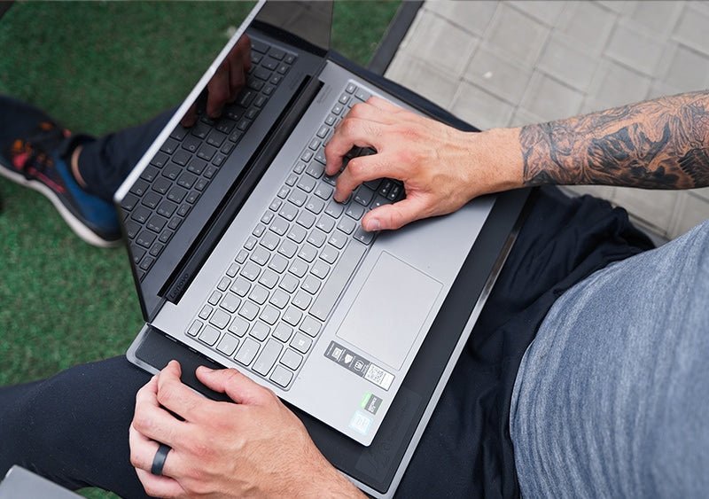 man using laptop outside in the Uk on a EMF Laptop Station