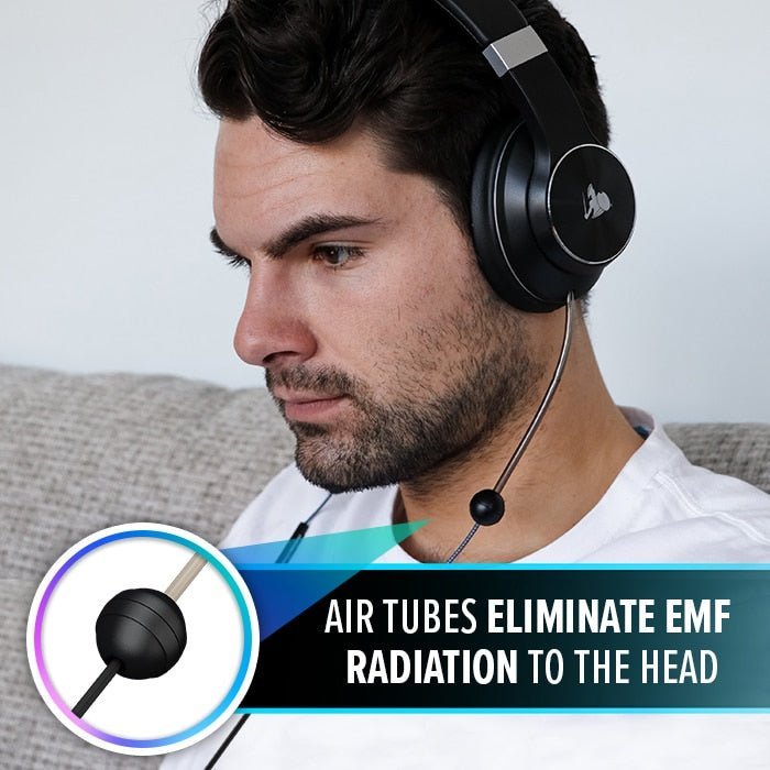 man listening inside a room on the sofa with Defendershield Air-Tube Headphones