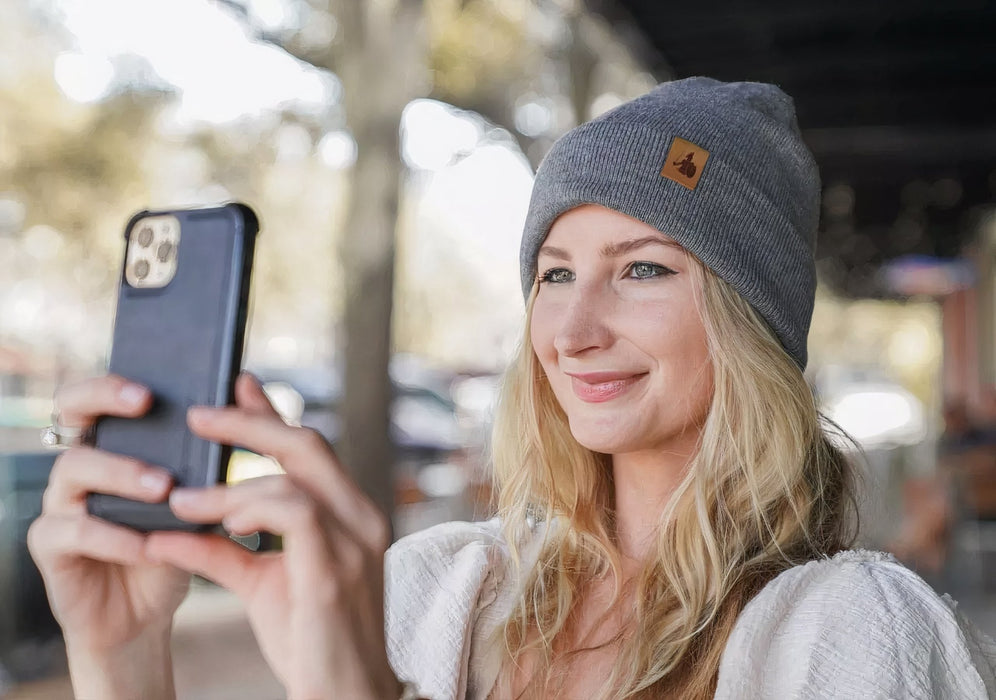 EMF Beanie being used by a girl outside whilst taking a selfie