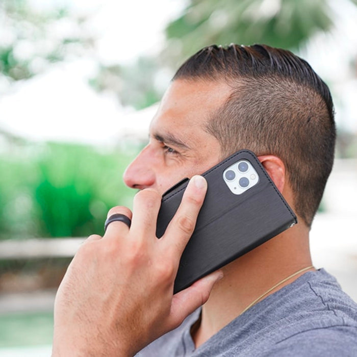 DefenderShield™ 5G EMF Protection iPhone 13 Series Phone Case being used by a man outside in the UK