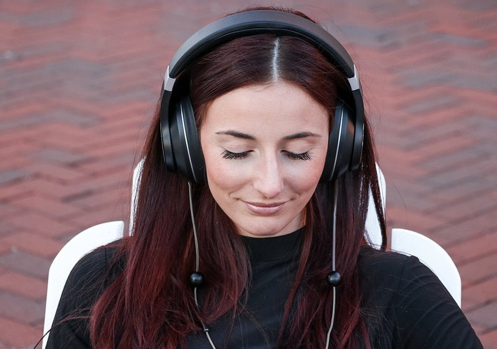 work women listening to Defendershield headphones outside in the UK