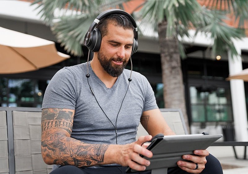man listening outside in public with Defendershield Air-Tube Headphones