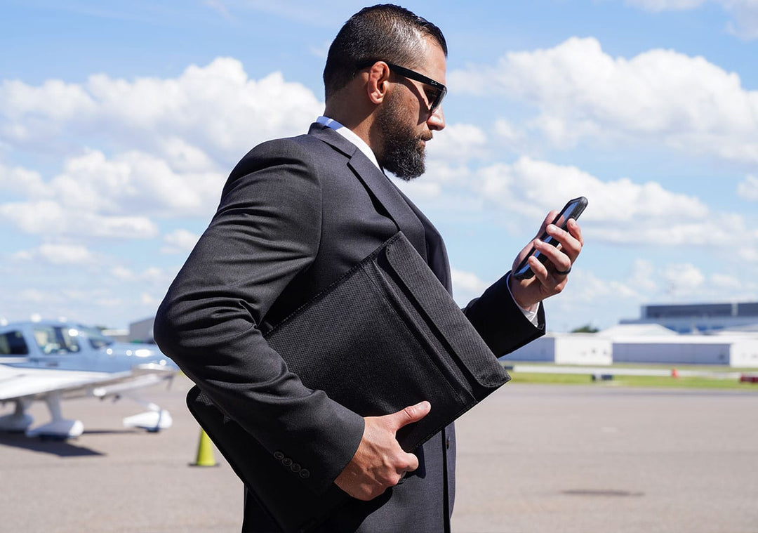 Laptop Sleeve being used in on-the-go by a man at the airport