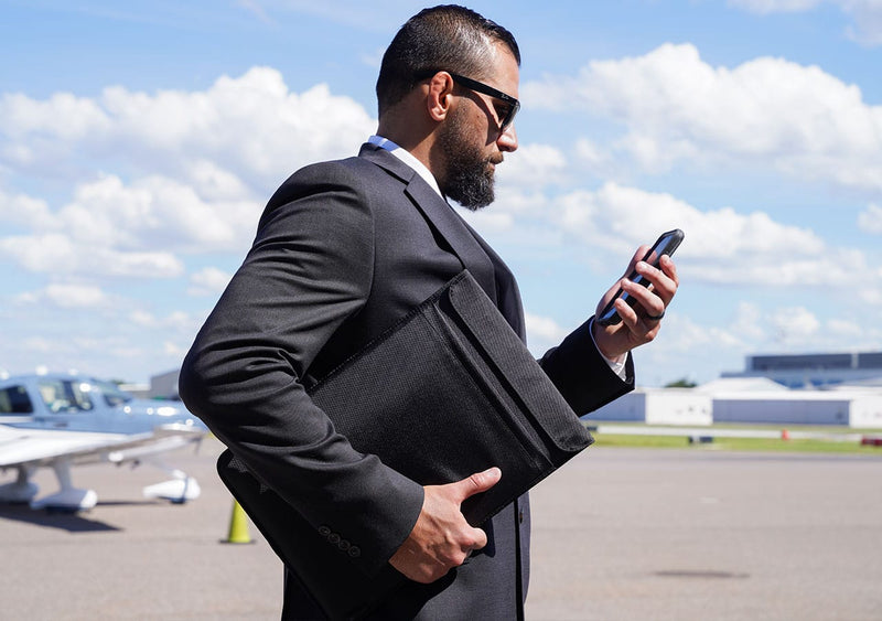 Laptop Sleeve being used in on-the-go by a man at the airport