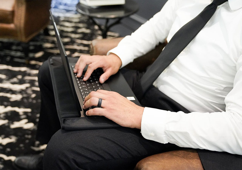 Laptop Sleeve being used in professional in a work setting by a man whilst sitting down