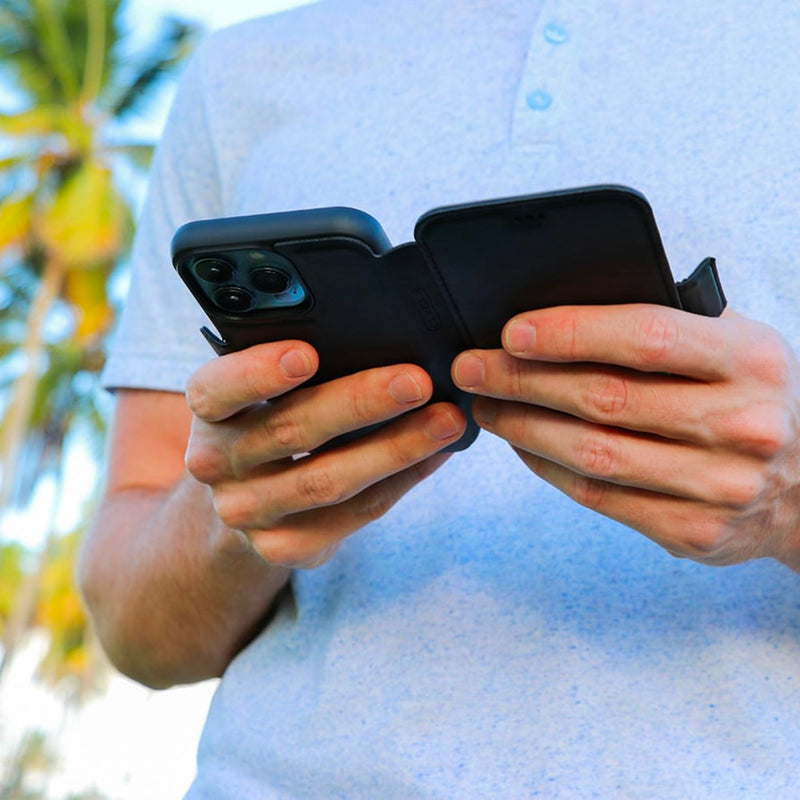 DefenderShield SlimFlip® iPhone 13 Series 5G EMF Phone Case being used in an outdoor setting