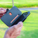 DefenderShield SlimFlip® iPhone 13 Series 5G EMF Phone Case being used in an outdoor setting