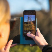 EMF Phone Case being used in public